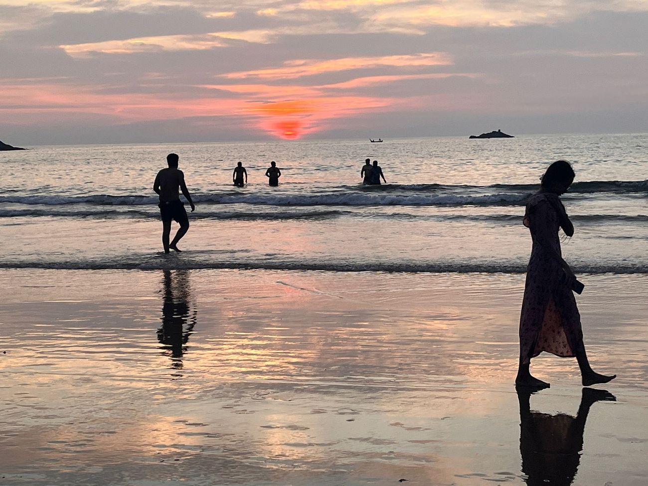 People walking in the sunset tide